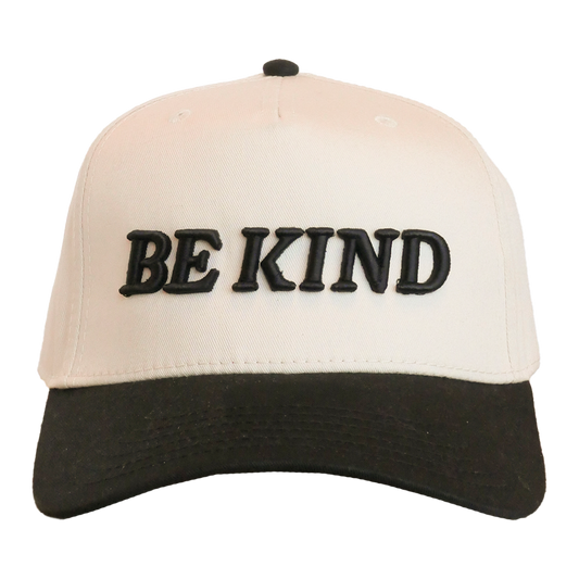 Beige and black cap with 'BE KIND' text on a white background