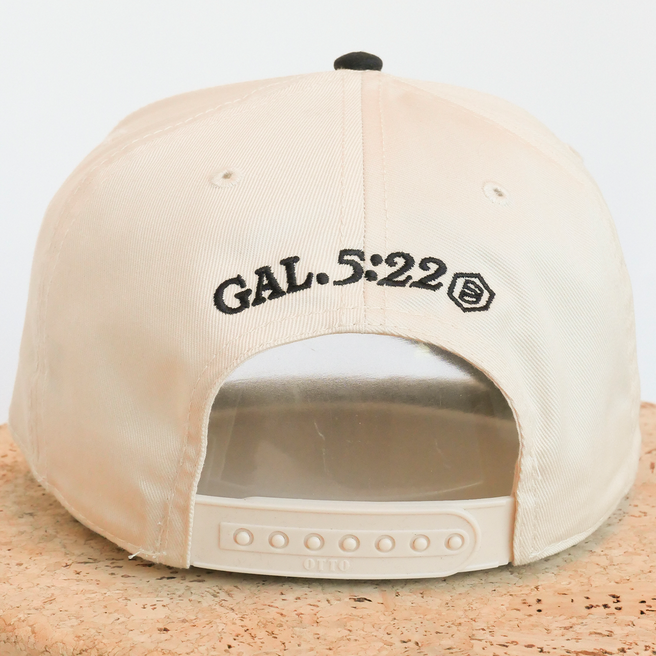Beige cap with 'GAL. 5:22' text on a light gray background
